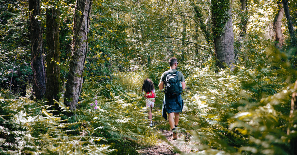 Two people walking in a field.
