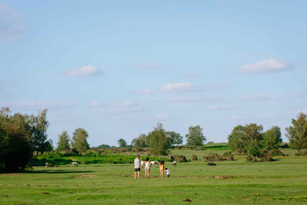 A family walking in a field.