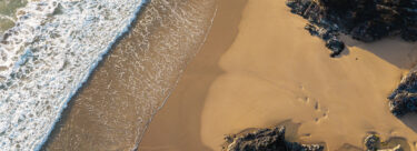 Holywell-Bay-Aerial-AdobeStock_1545965489-1920x700-1