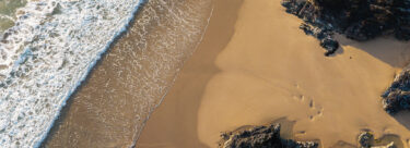Holywell-Bay-Aerial-AdobeStock_1545965489-1920x700-1
