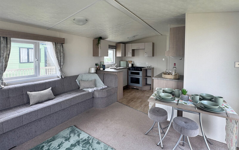 Cozy living room and dining area in a holiday home at Lovat Parks.