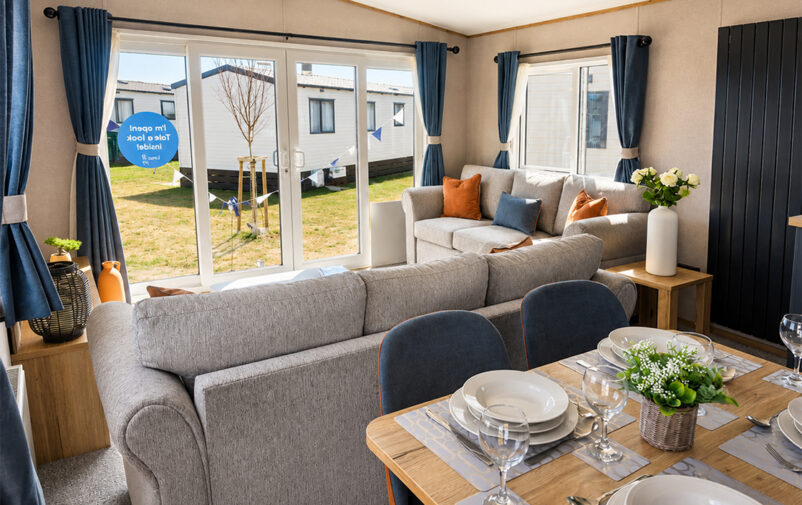 Spacious living area with large windows and contemporary furniture at Lovat Parks.