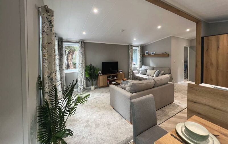 Modern living room at Victory Wisteria Lodge with comfortable sofas and natural light.