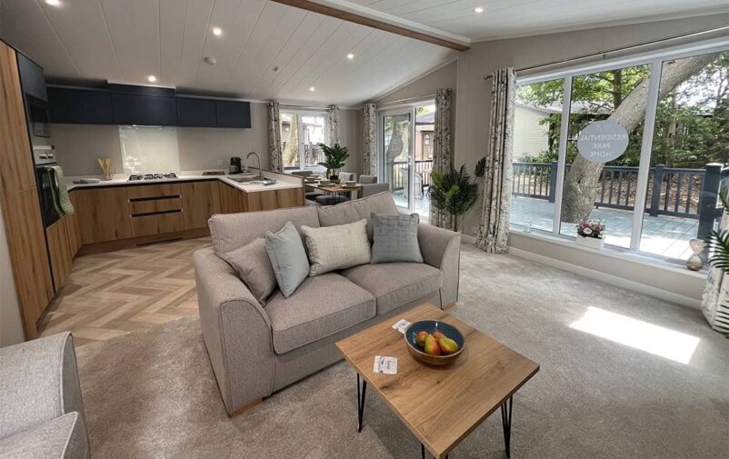 Spacious living room with large windows and modern decor at Victory Wisteria Lodge.