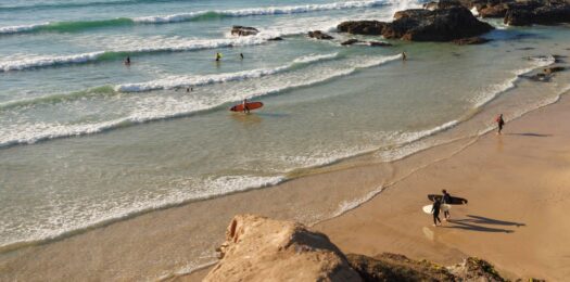 Surfers walking on the beach.