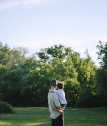 A man holding a child in his arms.