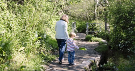 Two people walking in the forest.