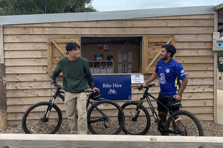 Two people at the bike hire point.