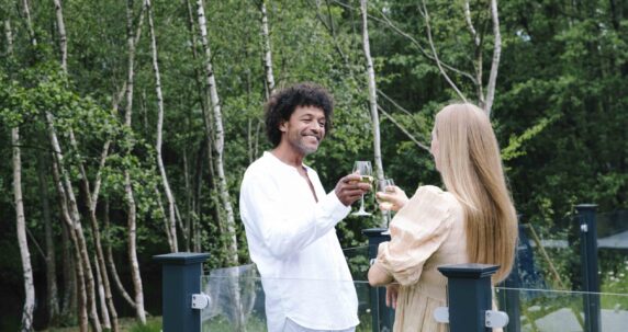 A couple on the deck of a lodge.