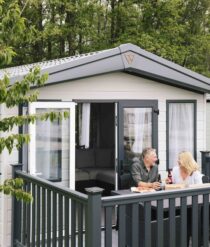 A couple on the deck of a caravan.