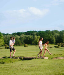 A family walking in a field.