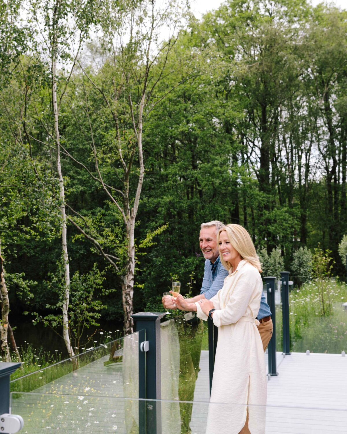 Couple standing on decking.