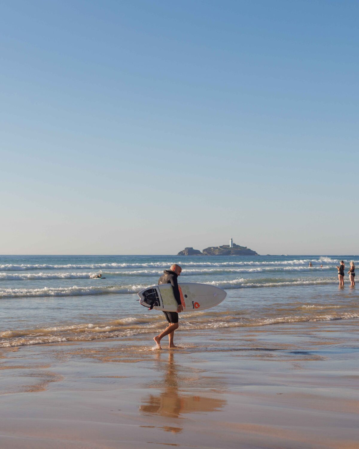 Man on the beach with a surf board.