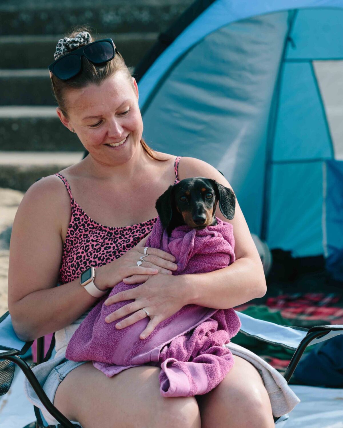 Woman holding dog.