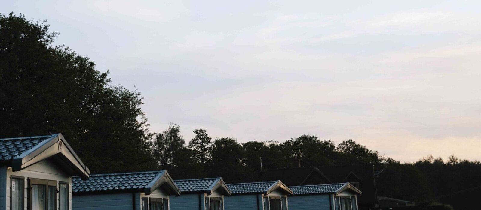 Row of caravans with the sun setting.