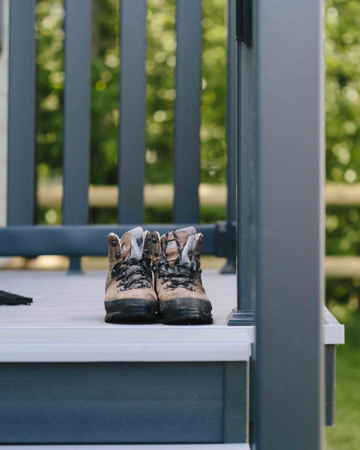 A pair of shoes on the stairs of a caravan.