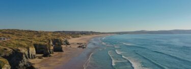 The beach with cliffs on the side.