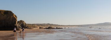 The beach with cliffs on the side.