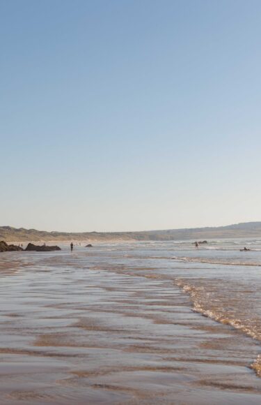 The beach with cliffs on the side.