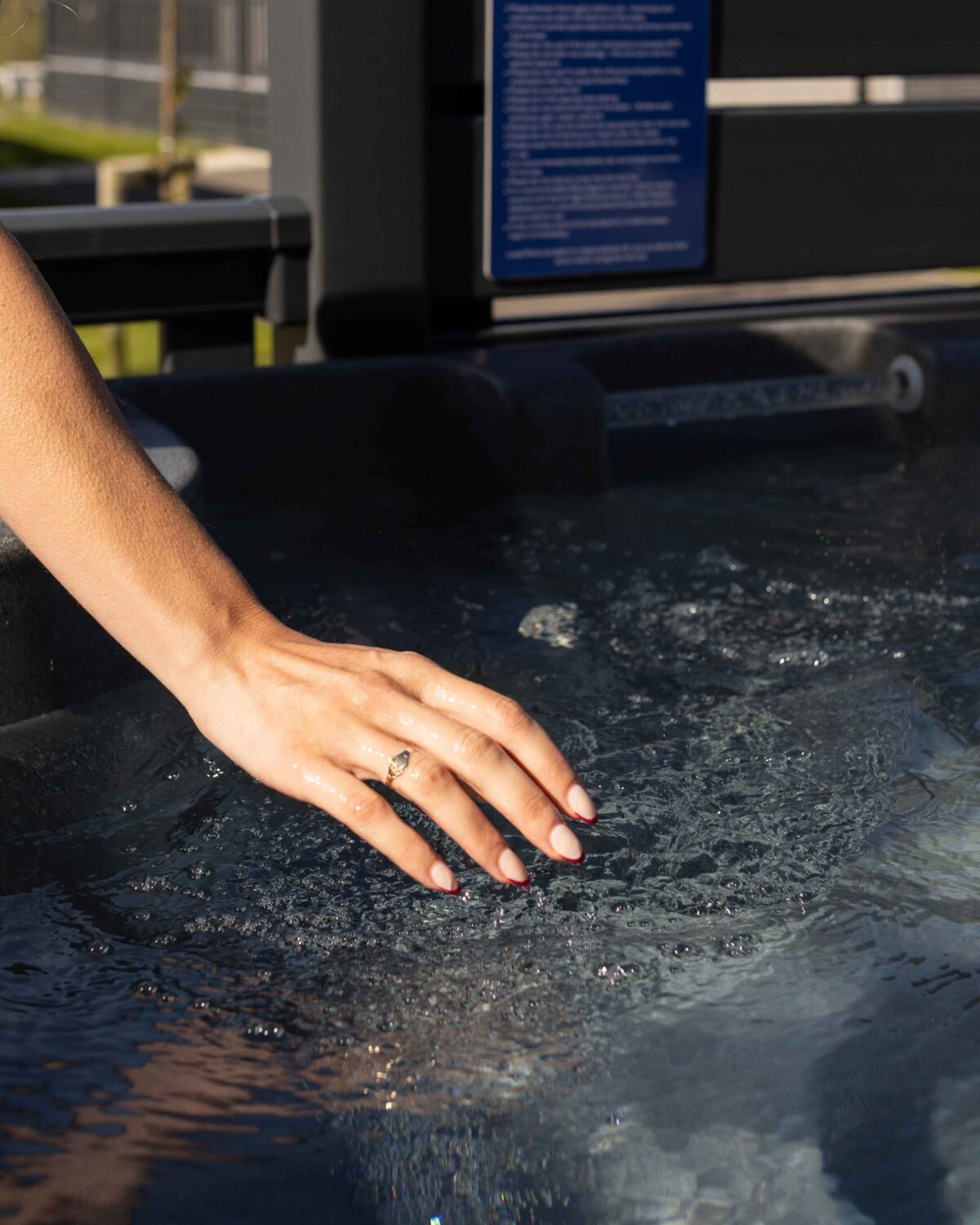 Someone touching a hot tub.